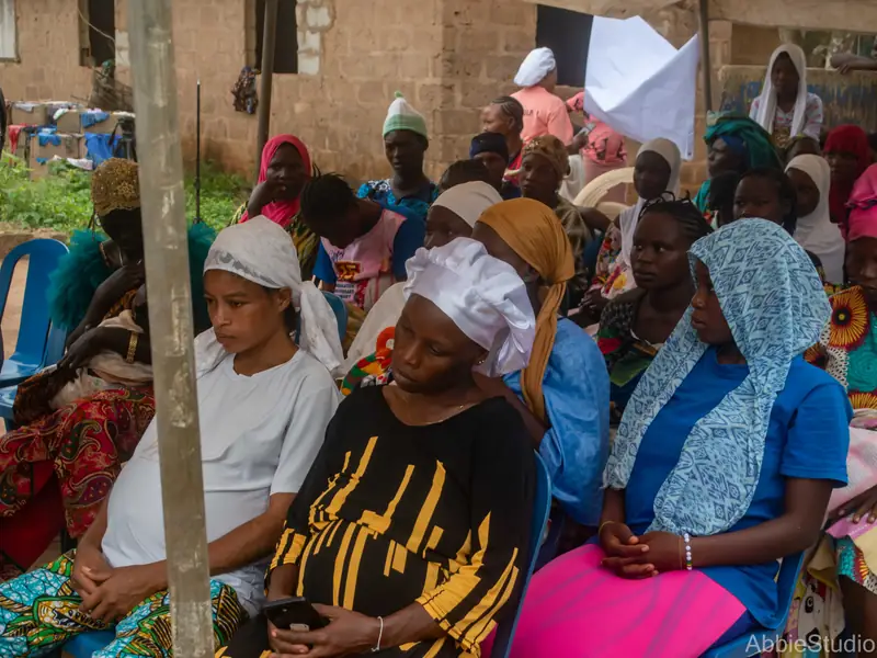 Women seated in rows, listening.
