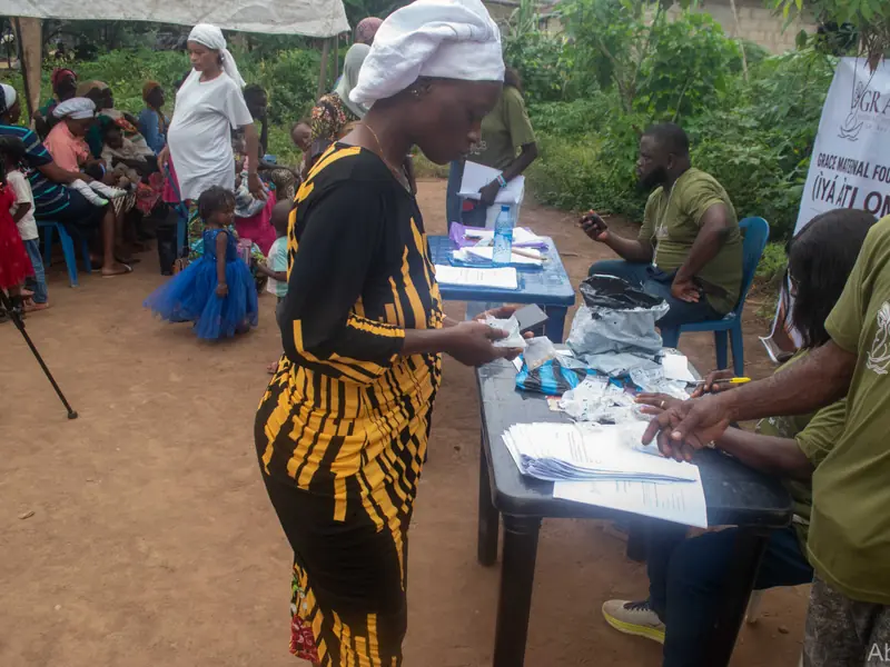 Volunteers at a table sorting packs and papers.