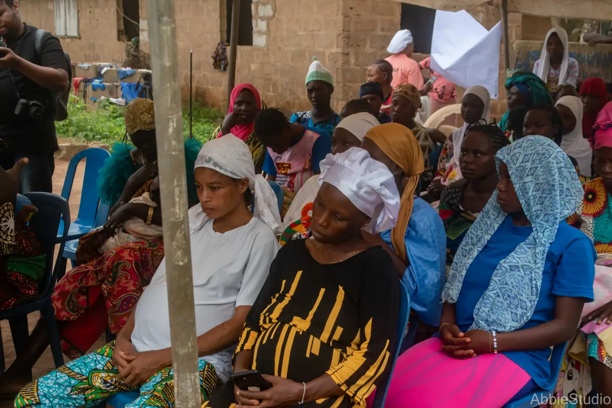 Women seated in rows at the Ikogbo outreach, listening.
