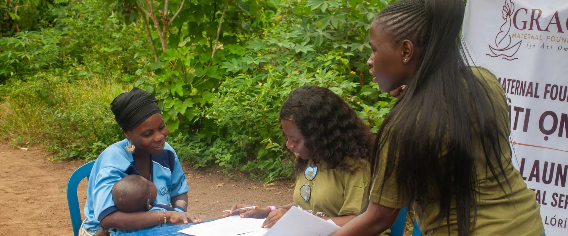 Volunteers at the registration table, writing.