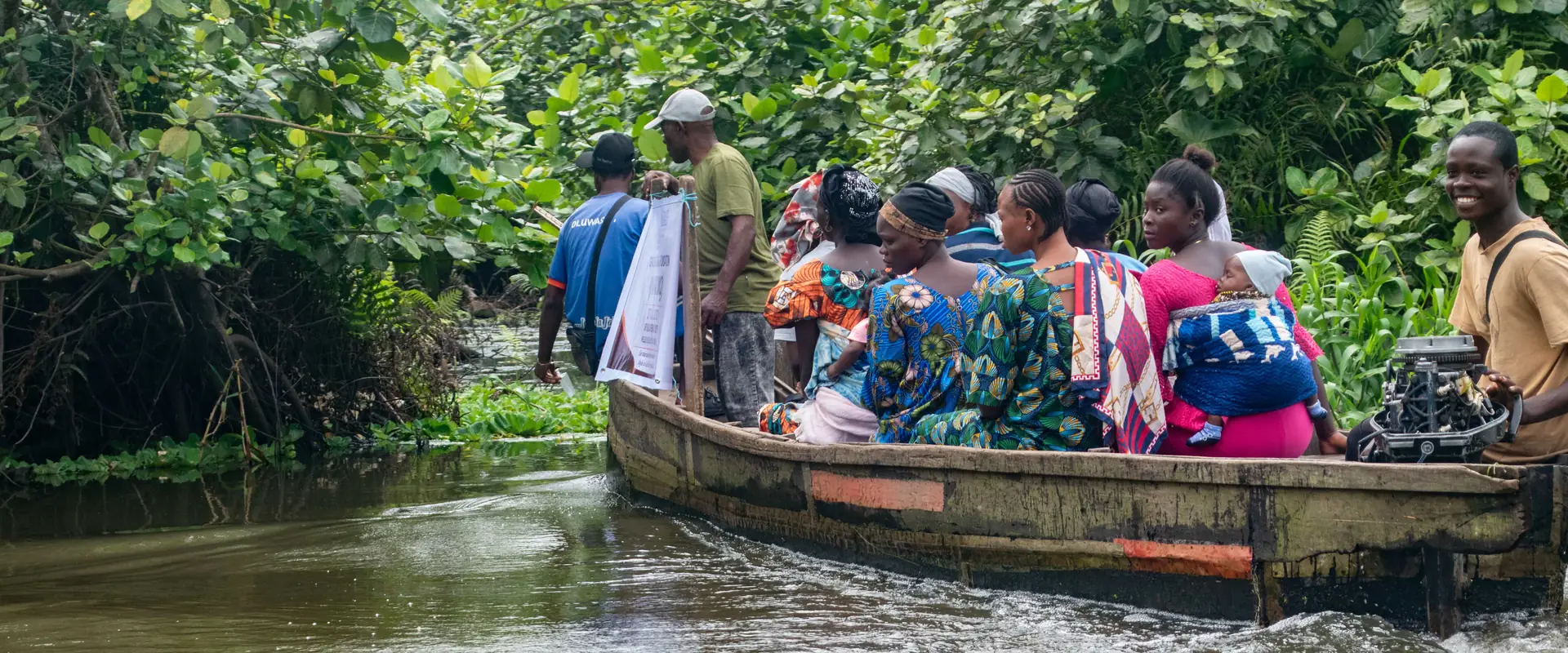 A boat carrying women and volunteers along the waterway to Ikogbo.